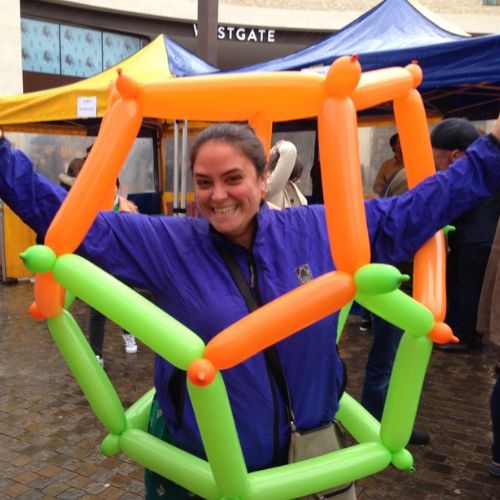 A lady inside a giant balloon dodecahedron that she made at a Bubbly Maths workshop