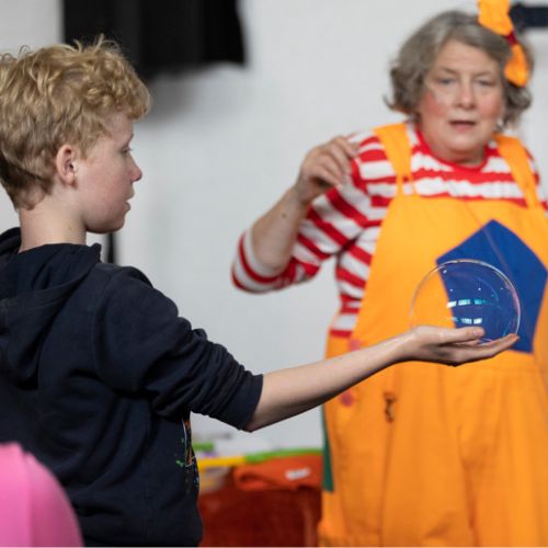 A child works how to hold a bubble during Science Week